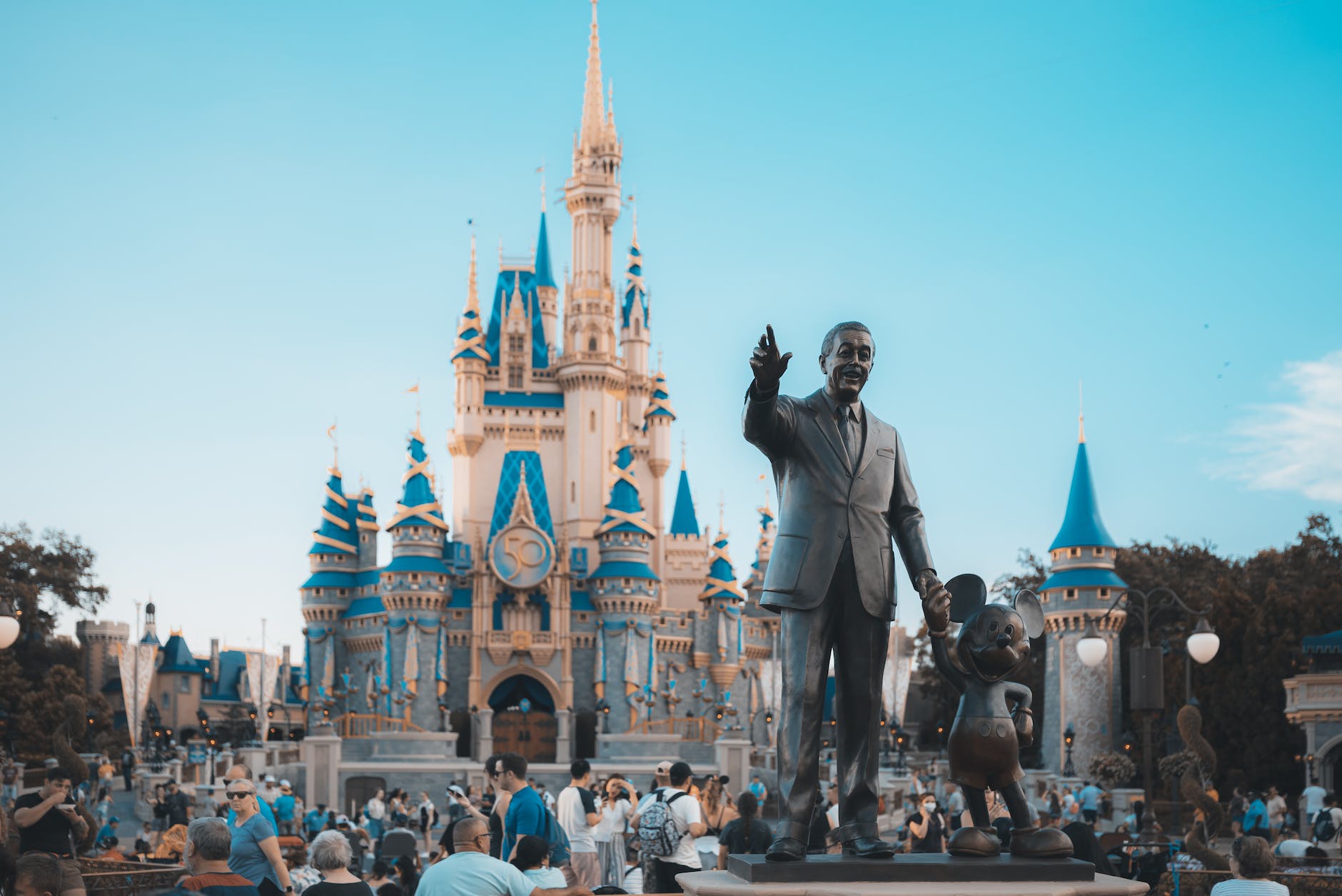 people walking around disney castle