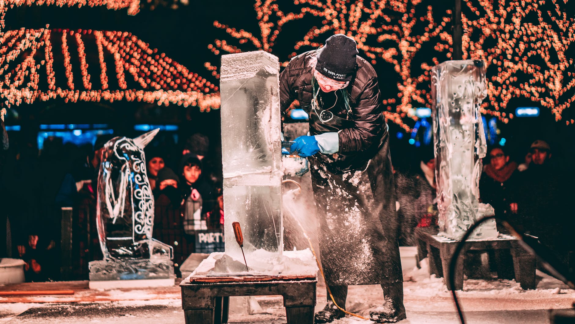 person carving ice sculptures