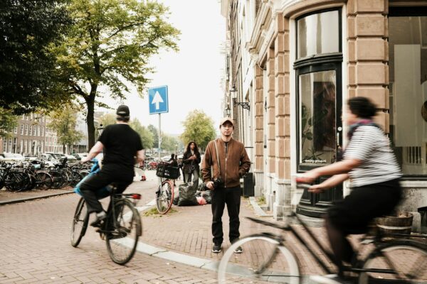 Revolutionary Rides: Scaling Amsterdam’s Underground and Norway’s Steep Hills man in jacket behind people on bicycles